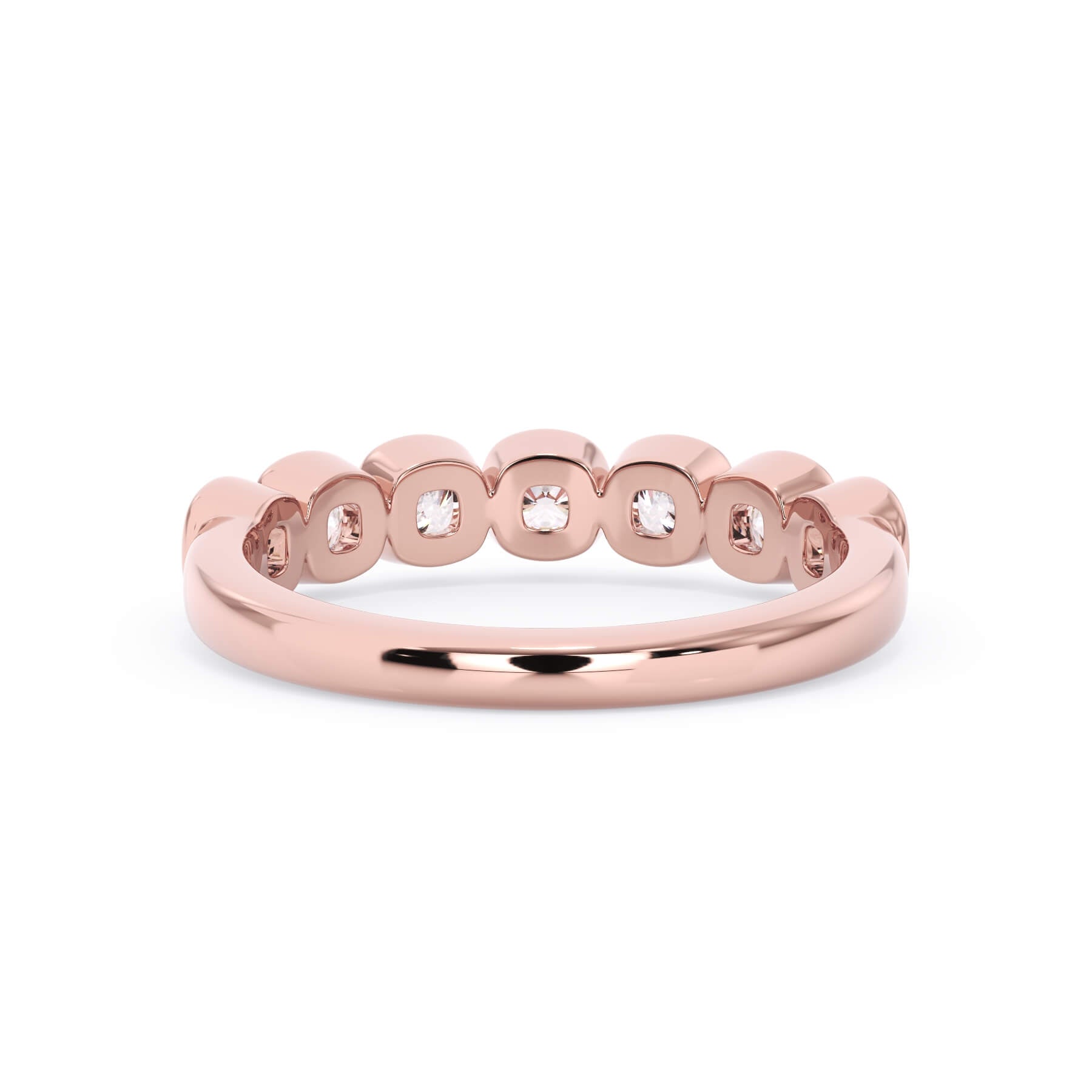 A picture of a seven stone diamond wedding ring with cushion cut diamonds that are bezel set in rose gold on a white background with a view of the underside of the ring.