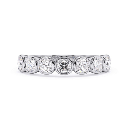 A picture of a seven stone diamond wedding ring with cushion cut diamonds that are bezel set in white gold or platinum on a white background with the ring facing forward, lying down.