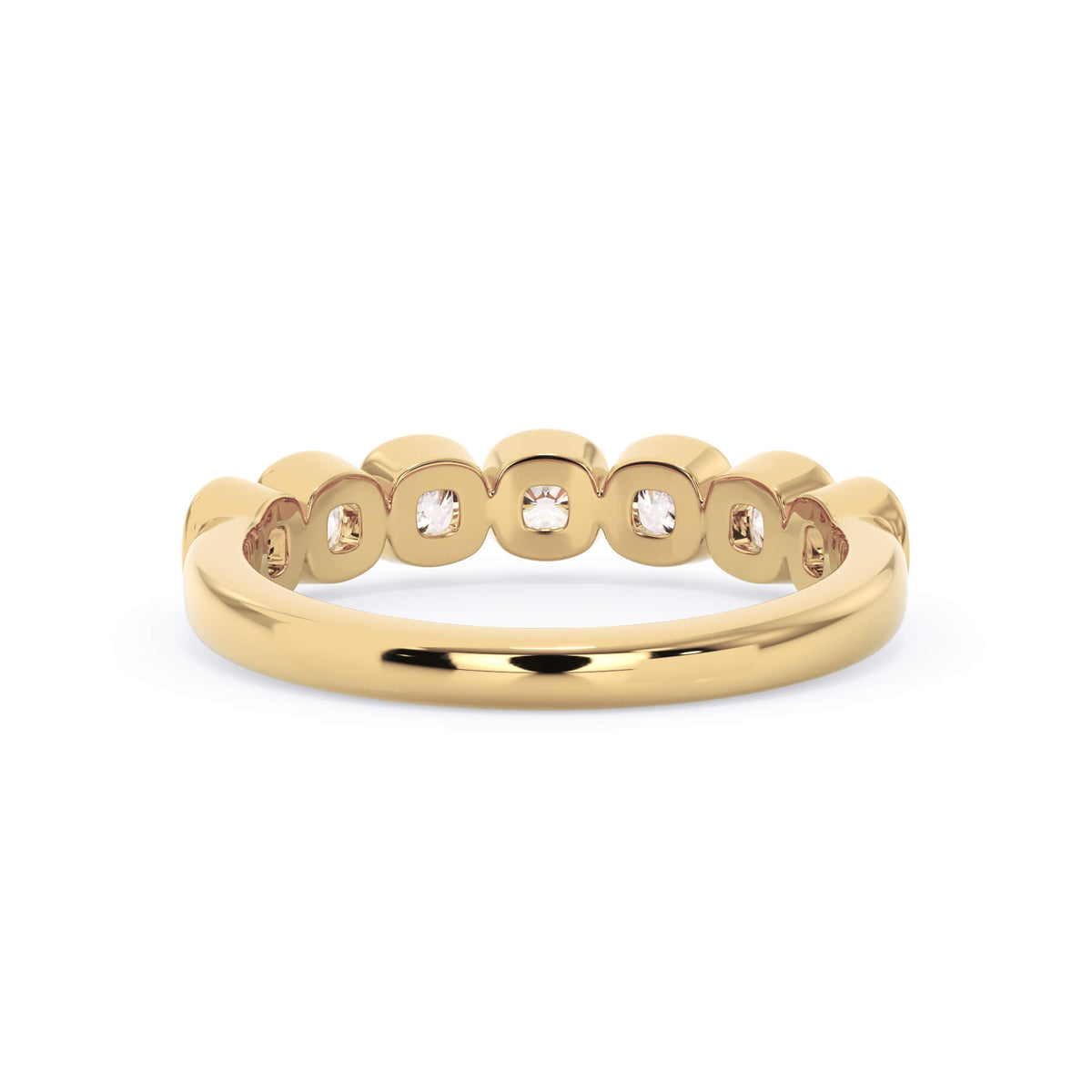 A picture of a seven stone diamond wedding ring with cushion cut diamonds that are bezel set in yellow gold on a white background with a view of the underside of the ring.