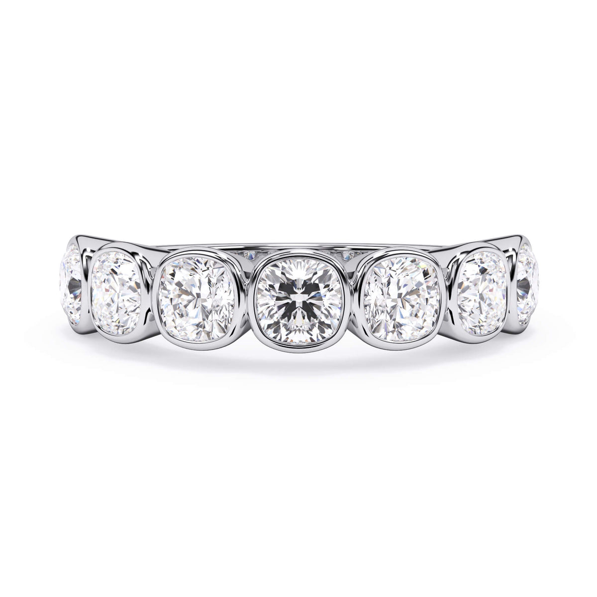A picture of a seven stone diamond wedding ring with cushion cut diamonds that are bezel set in white gold or platinum on a white background with the ring facing forward, lying down.