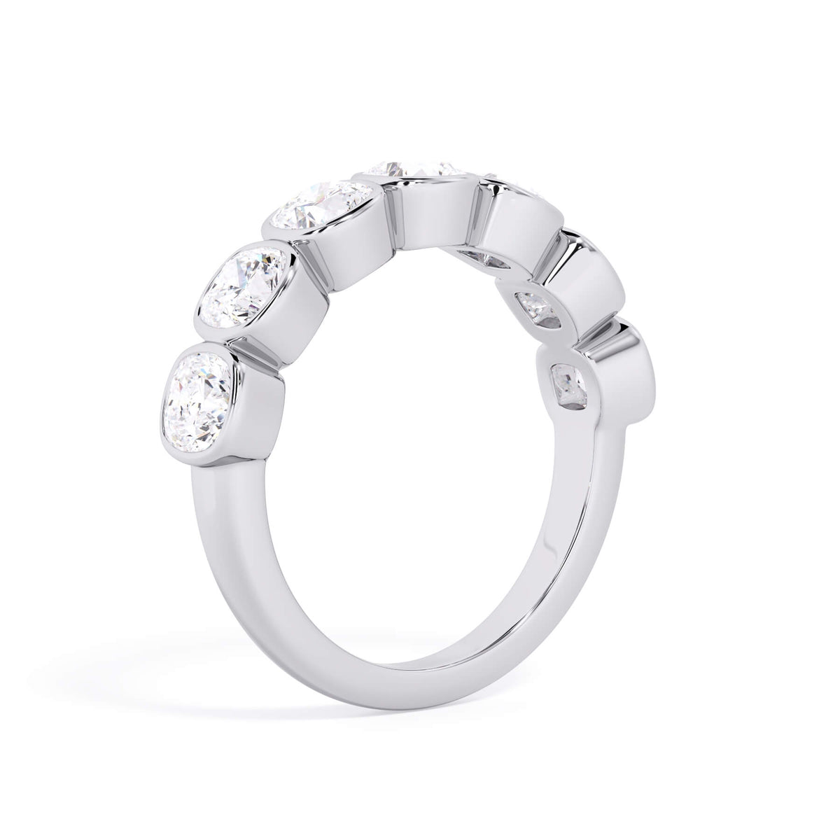 A picture of a seven stone diamond wedding ring with cushion cut diamonds that are bezel set in white gold or platinum on a white background with the ring facing forward, lying down.