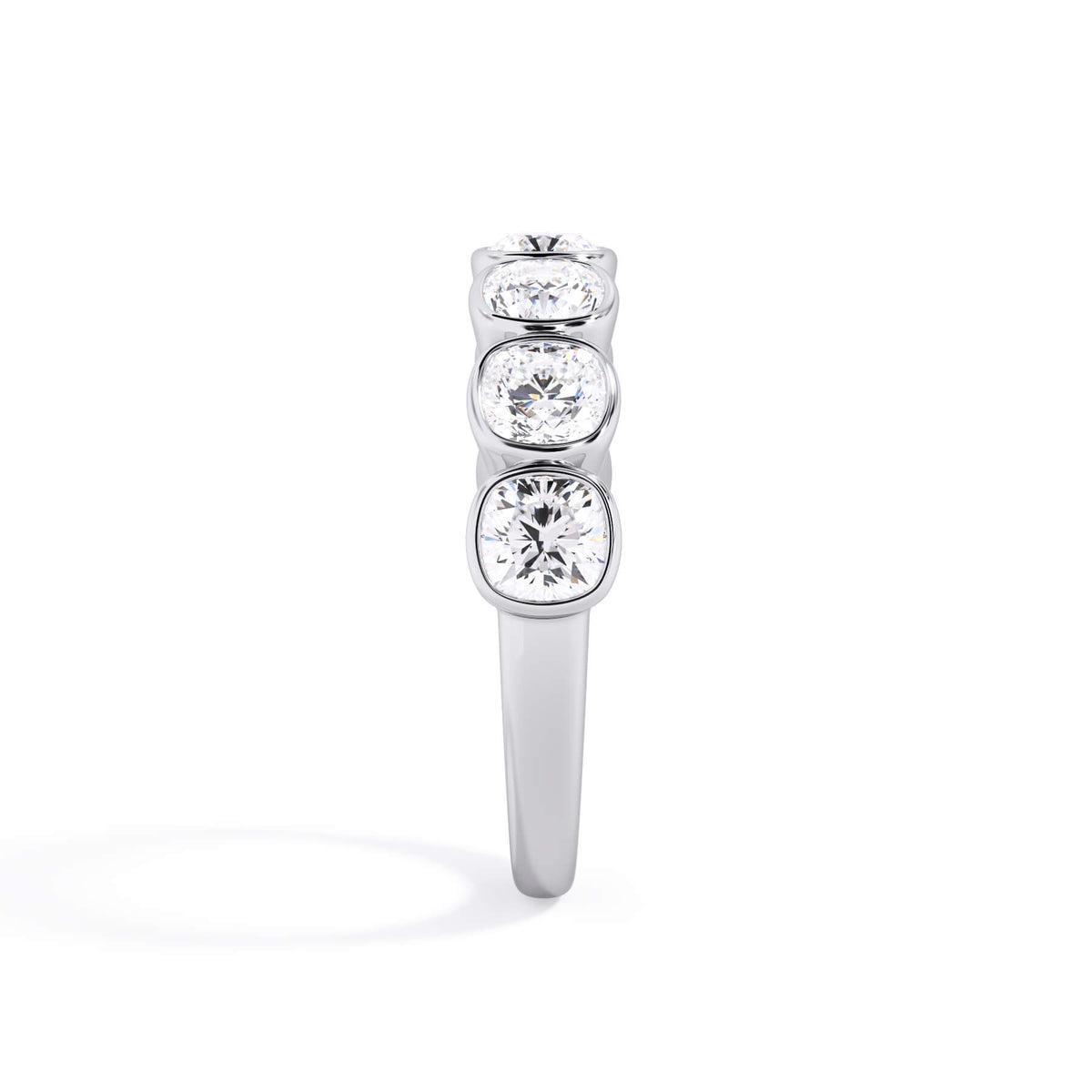 A picture of a seven stone diamond wedding ring with cushion cut diamonds that are bezel set in white gold or platinum on a white background with the ring facing forward, lying down.