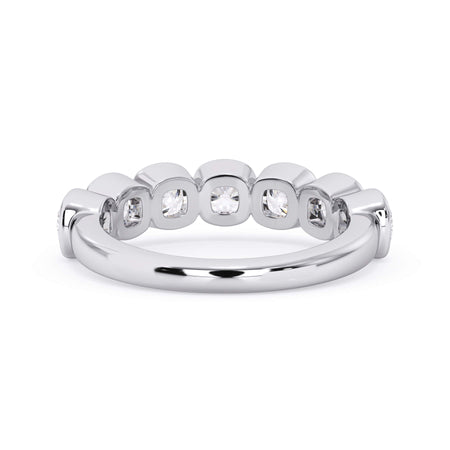 A picture of a seven stone diamond wedding ring with cushion cut diamonds that are bezel set in white gold or platinum on a white background with the ring facing forward, lying down.