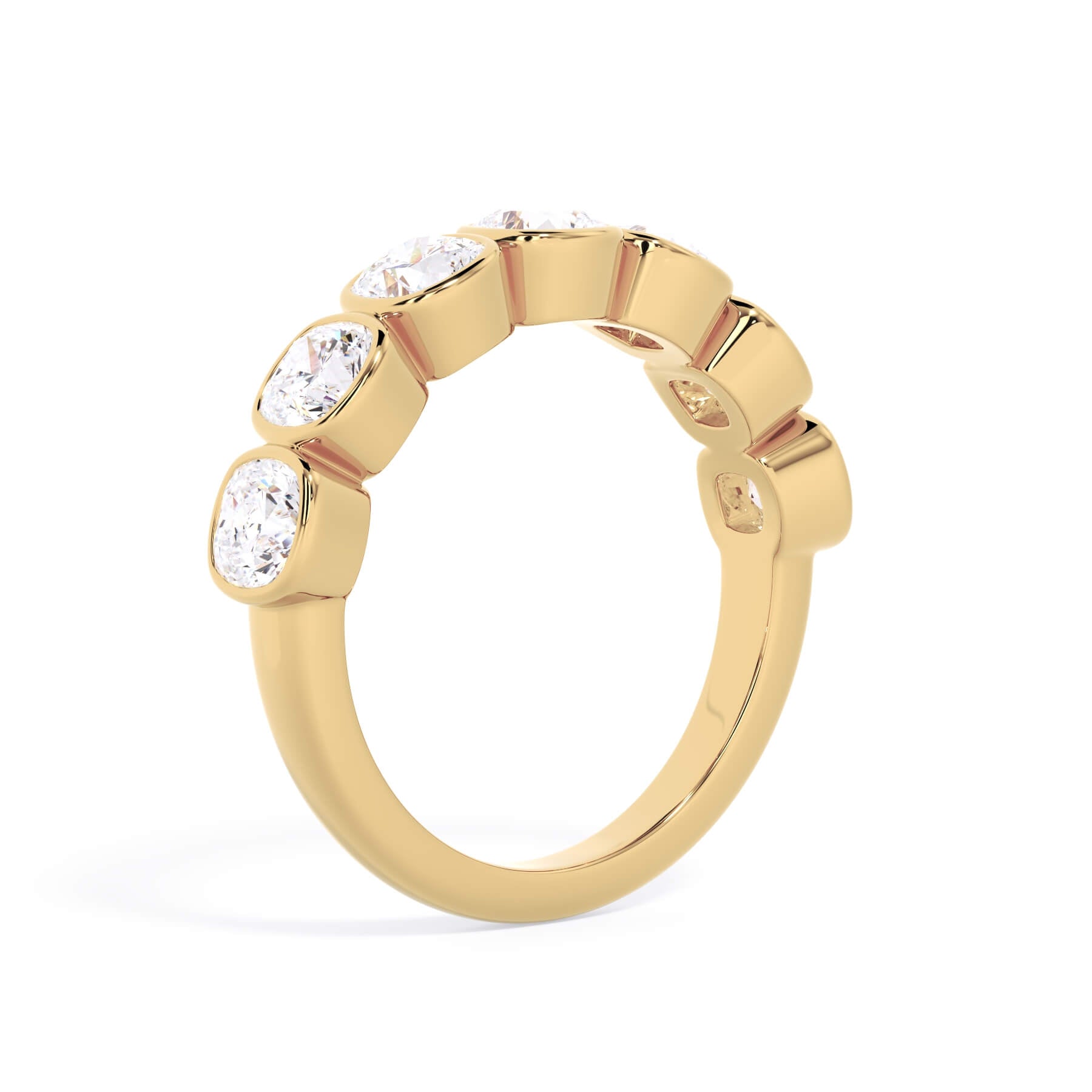 A picture of a seven stone diamond wedding ring with cushion cut diamonds that are bezel set in yellow gold on a white background with a slightly angled, through the finger view.