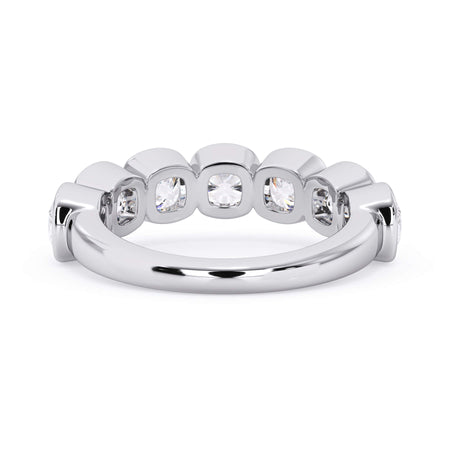 A picture of a seven stone diamond wedding ring with cushion cut diamonds that are bezel set in white gold or platinum on a white background with a view of the underside of the ring.