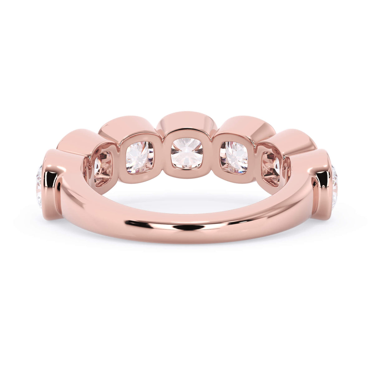 A picture of a seven stone diamond wedding ring with cushion cut diamonds that are bezel set in rose gold on a white background with a view of the underside of the ring.