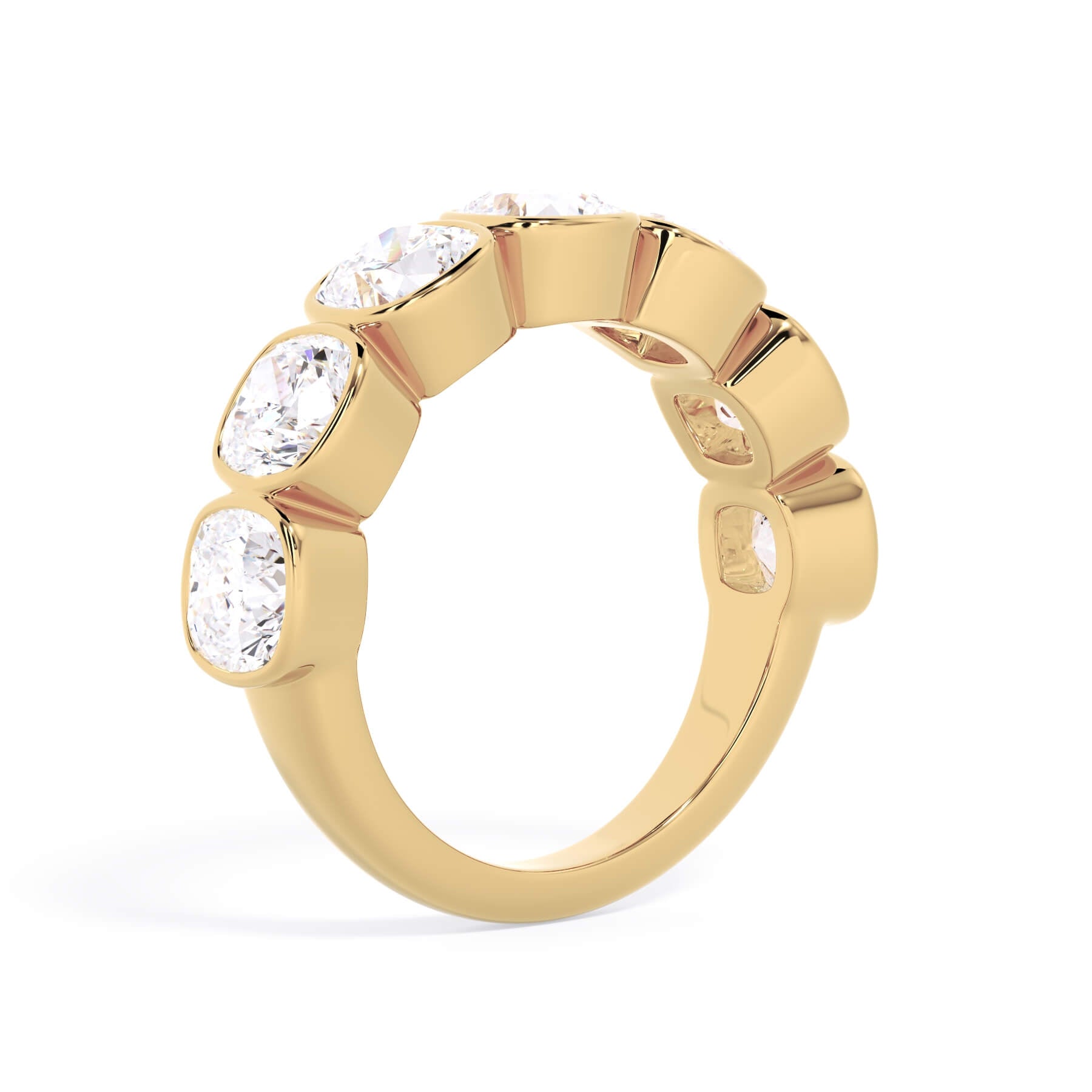 A picture of a seven stone diamond wedding ring with cushion cut diamonds that are bezel set in yellow gold on a white background with a slightly angled, through the finger view.