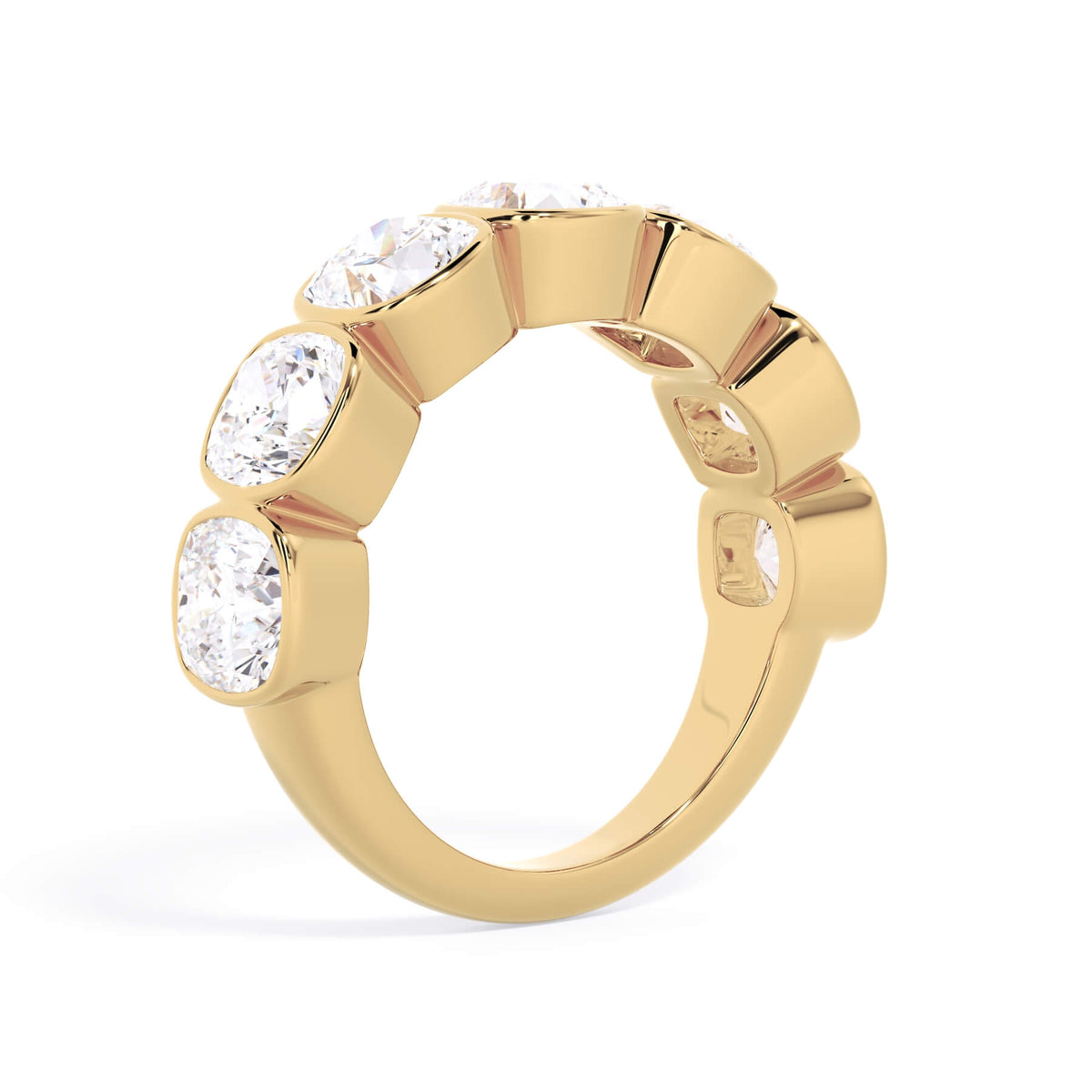 A picture of a seven stone diamond wedding ring with cushion cut diamonds that are bezel set in yellow gold on a white background with a slightly angled, through the finger view.