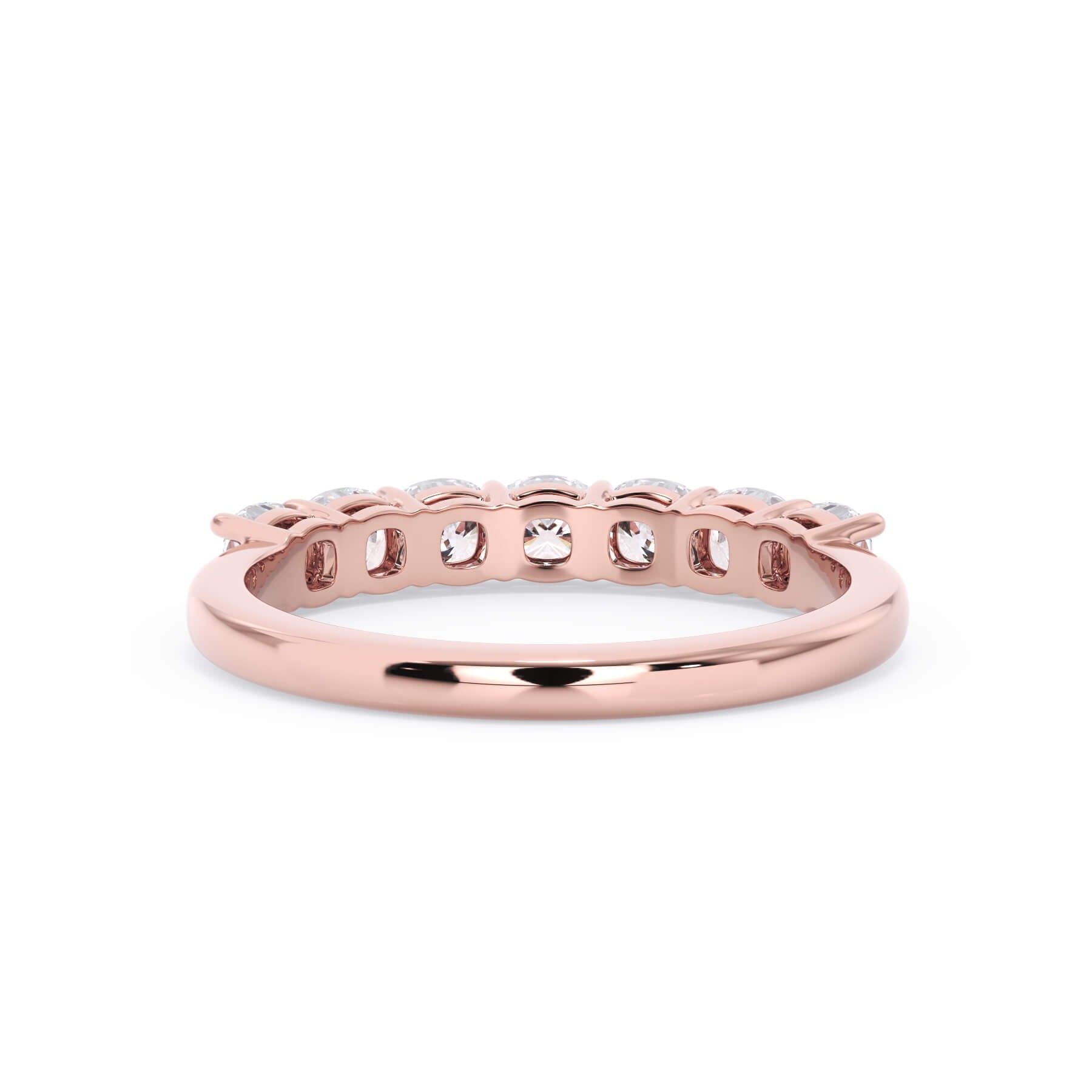 A picture of a seven stone diamond wedding ring with cushion cut diamonds that are shared prong set in rose gold on a white background with a view of the underside of the ring.