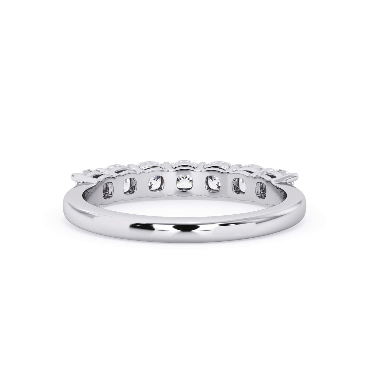A picture of a seven stone diamond wedding ring with cushion cut diamonds that are shared prong set in white gold or platinum on a white background with a view of the underside of the ring.