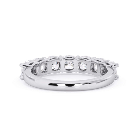A picture of a seven stone diamond wedding ring with cushion cut diamonds that are shared prong set in white gold or platinum on a white background with a view of the underside of the ring.