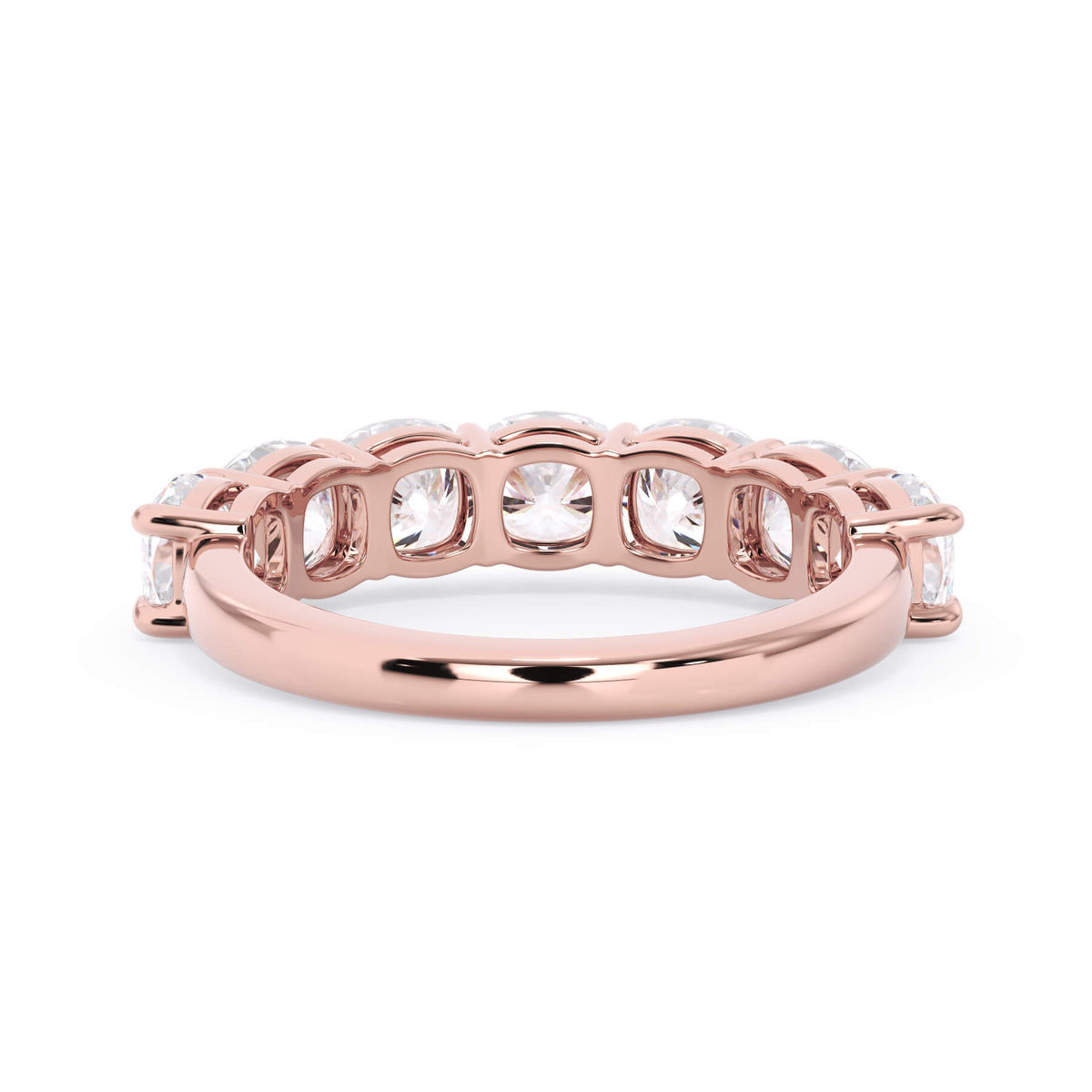 A picture of a seven stone diamond wedding ring with cushion cut diamonds that are shared prong set in rose gold on a white background with a view of the underside of the ring.