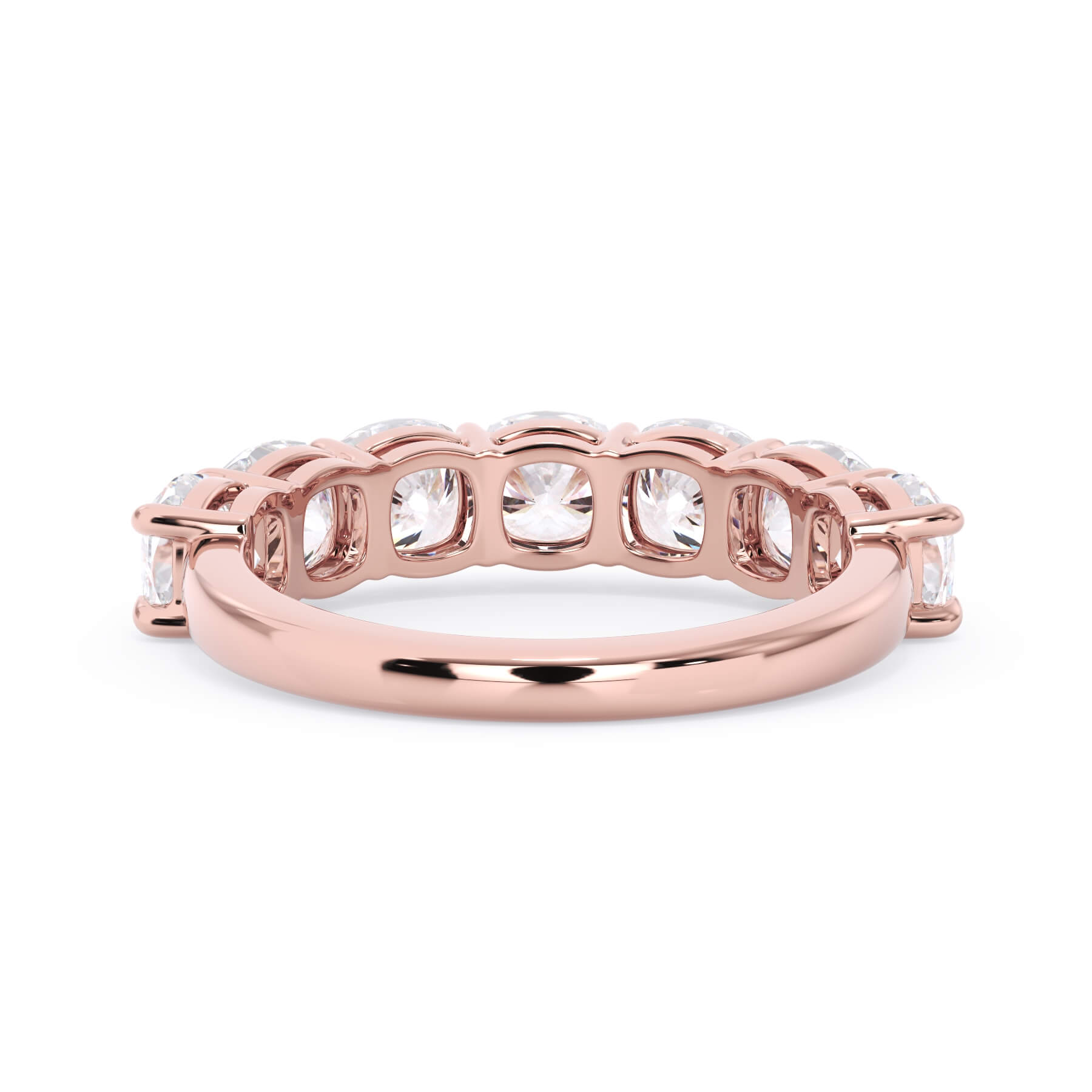 A picture of a seven stone diamond wedding ring with cushion cut diamonds that are shared prong set in rose gold on a white background with a view of the underside of the ring.