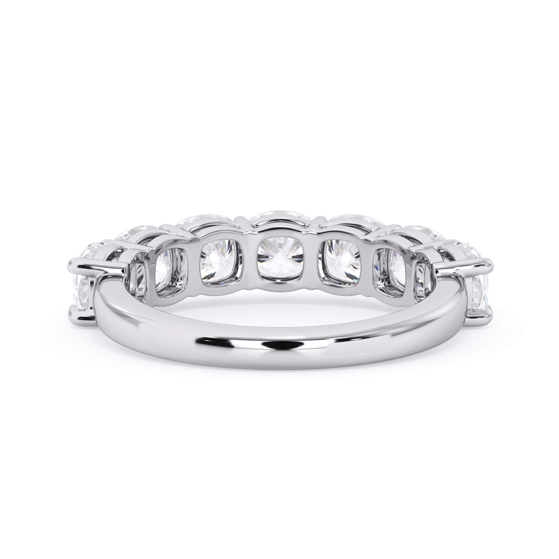 A picture of a seven stone diamond wedding ring with cushion cut diamonds that are shared prong set in white gold or platinum on a white background with a view of the underside of the ring.