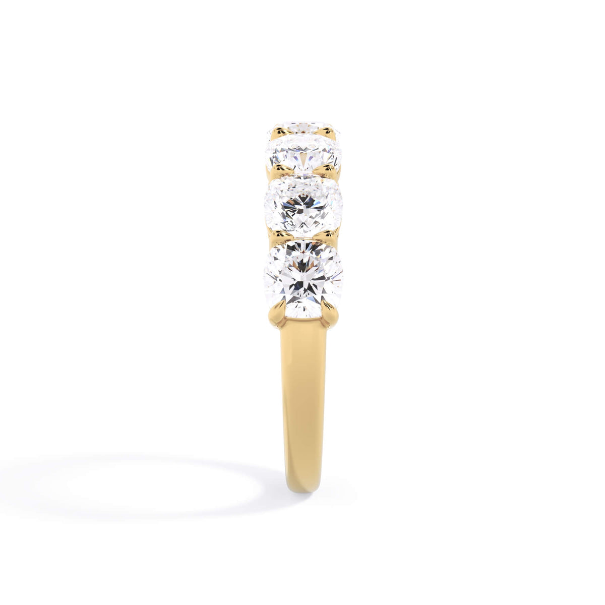 A picture of a seven stone diamond wedding ring with cushion cut diamonds that are shared prong set in yellow gold on a white background with a side profile view.