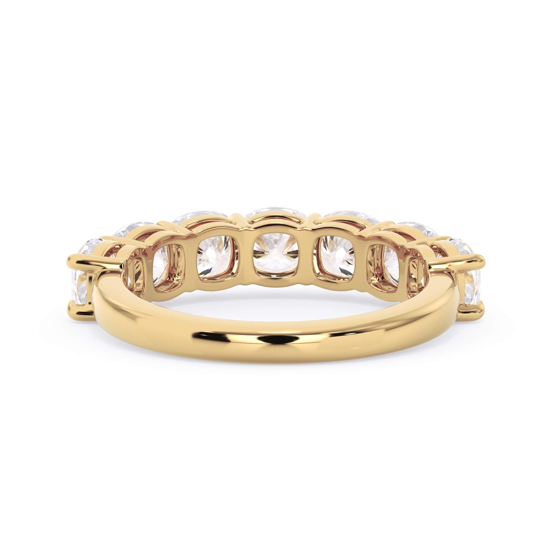 A picture of a seven stone diamond wedding ring with cushion cut diamonds that are shared prong set in yellow gold on a white background with a view of the underside of the ring.