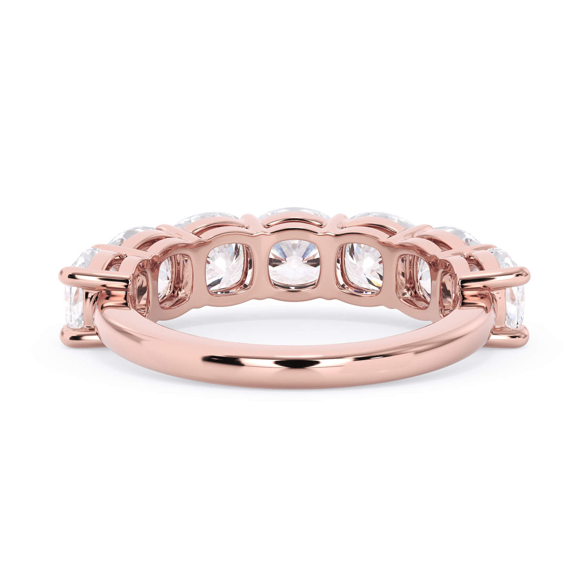 A picture of a seven stone diamond wedding ring with cushion cut diamonds that are shared prong set in rose gold on a white background with a view of the underside of the ring.