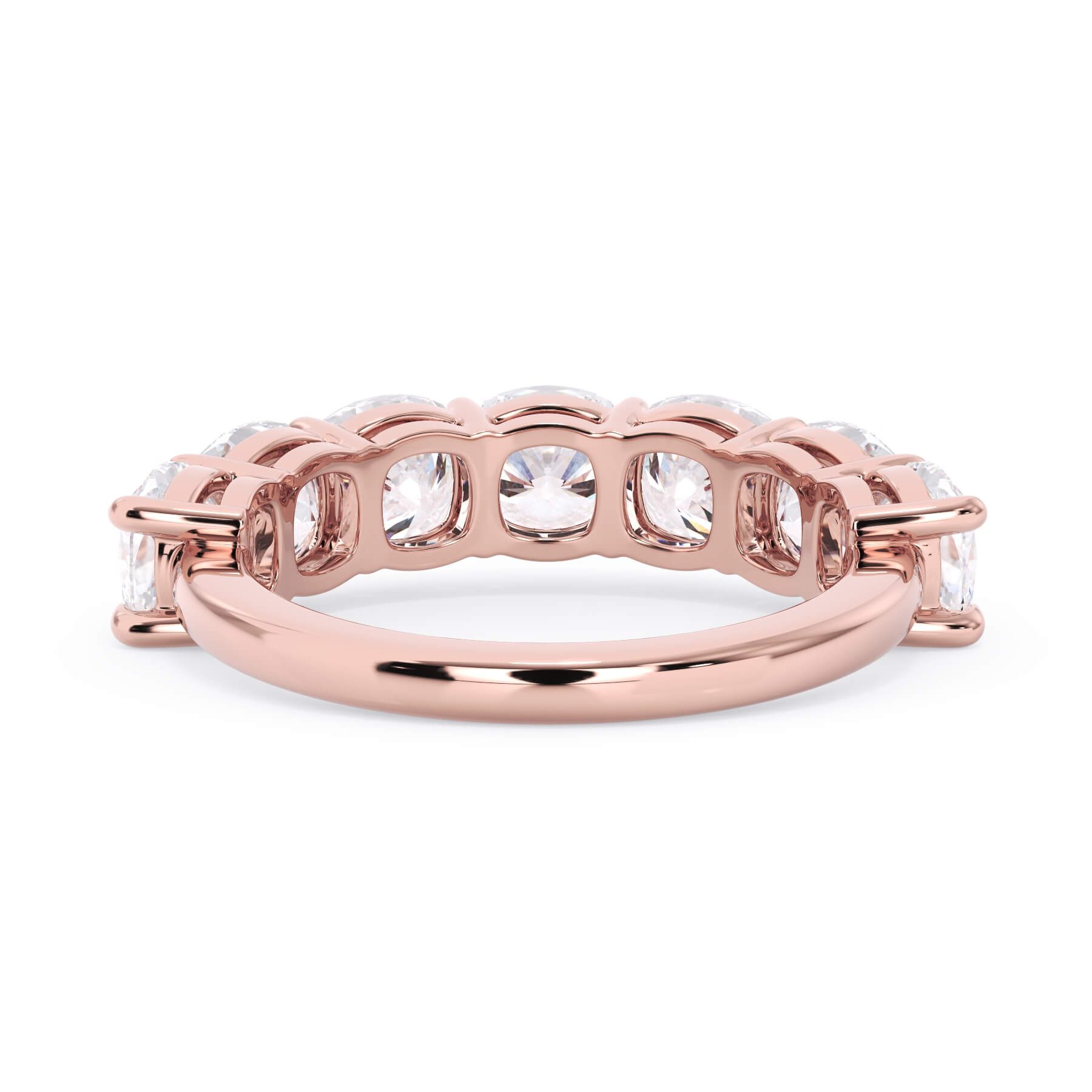 A picture of a seven stone diamond wedding ring with cushion cut diamonds that are shared prong set in rose gold on a white background with a view of the underside of the ring.