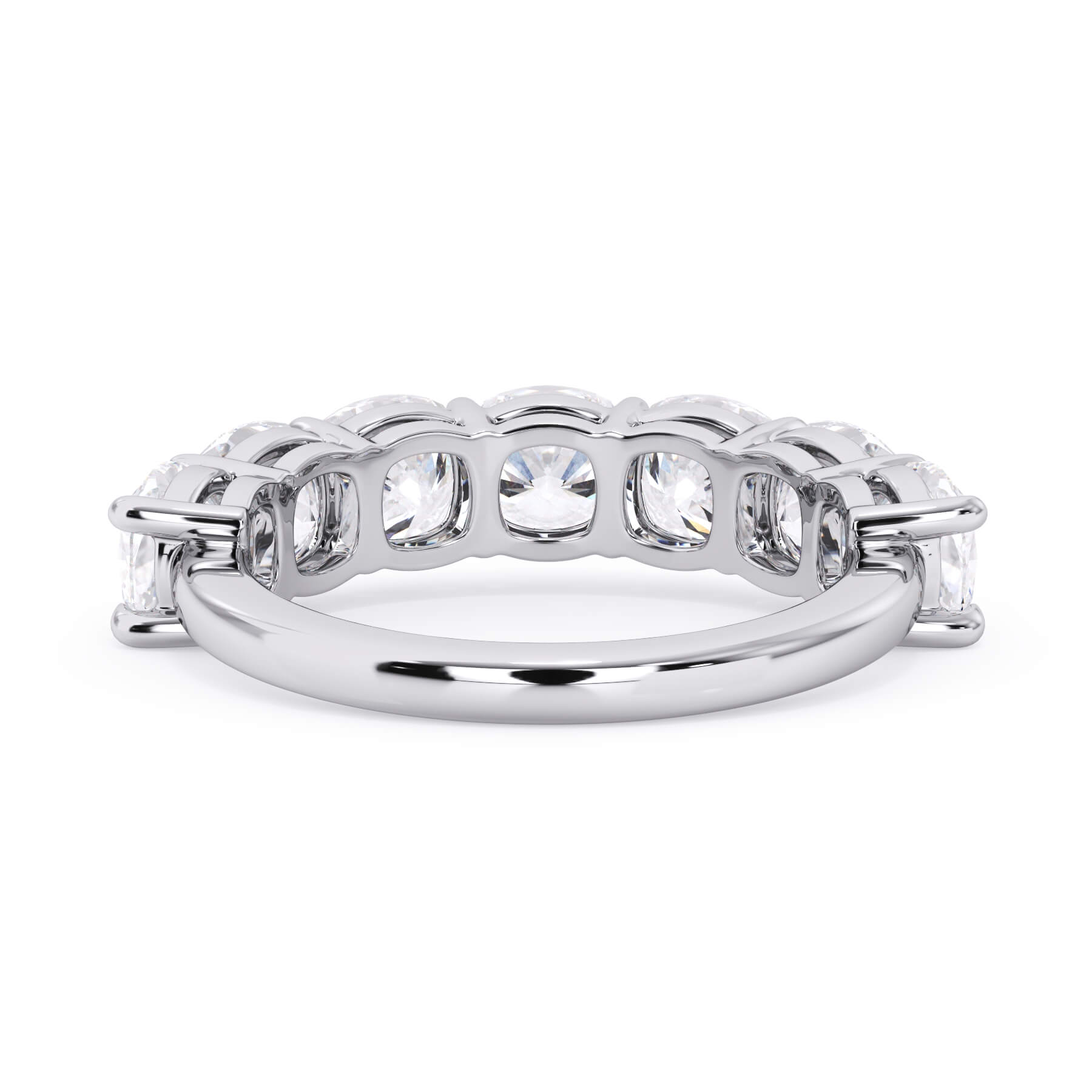 A picture of a seven stone diamond wedding ring with cushion cut diamonds that are shared prong set in white gold or platinum on a white background with a view of the underside of the ring.