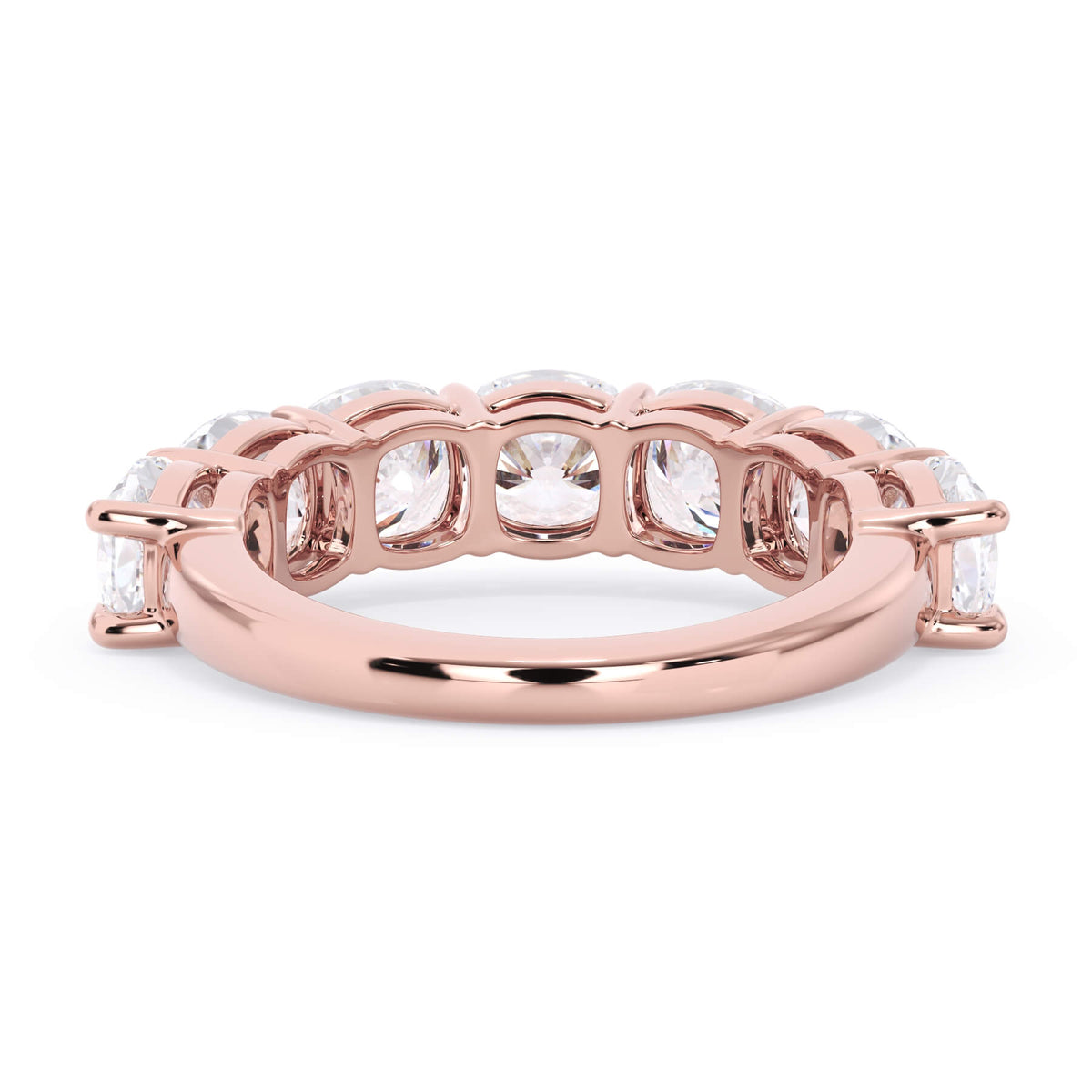 A picture of a seven stone diamond wedding ring with cushion cut diamonds that are shared prong set in rose gold on a white background with a view of the underside of the ring.