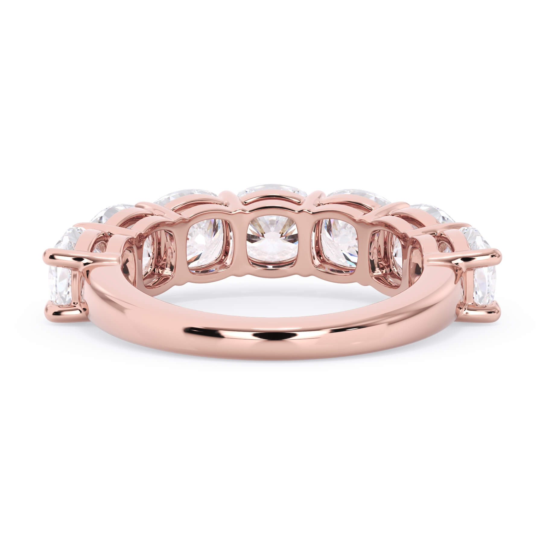 A picture of a seven stone diamond wedding ring with cushion cut diamonds that are shared prong set in rose gold on a white background with a view of the underside of the ring.