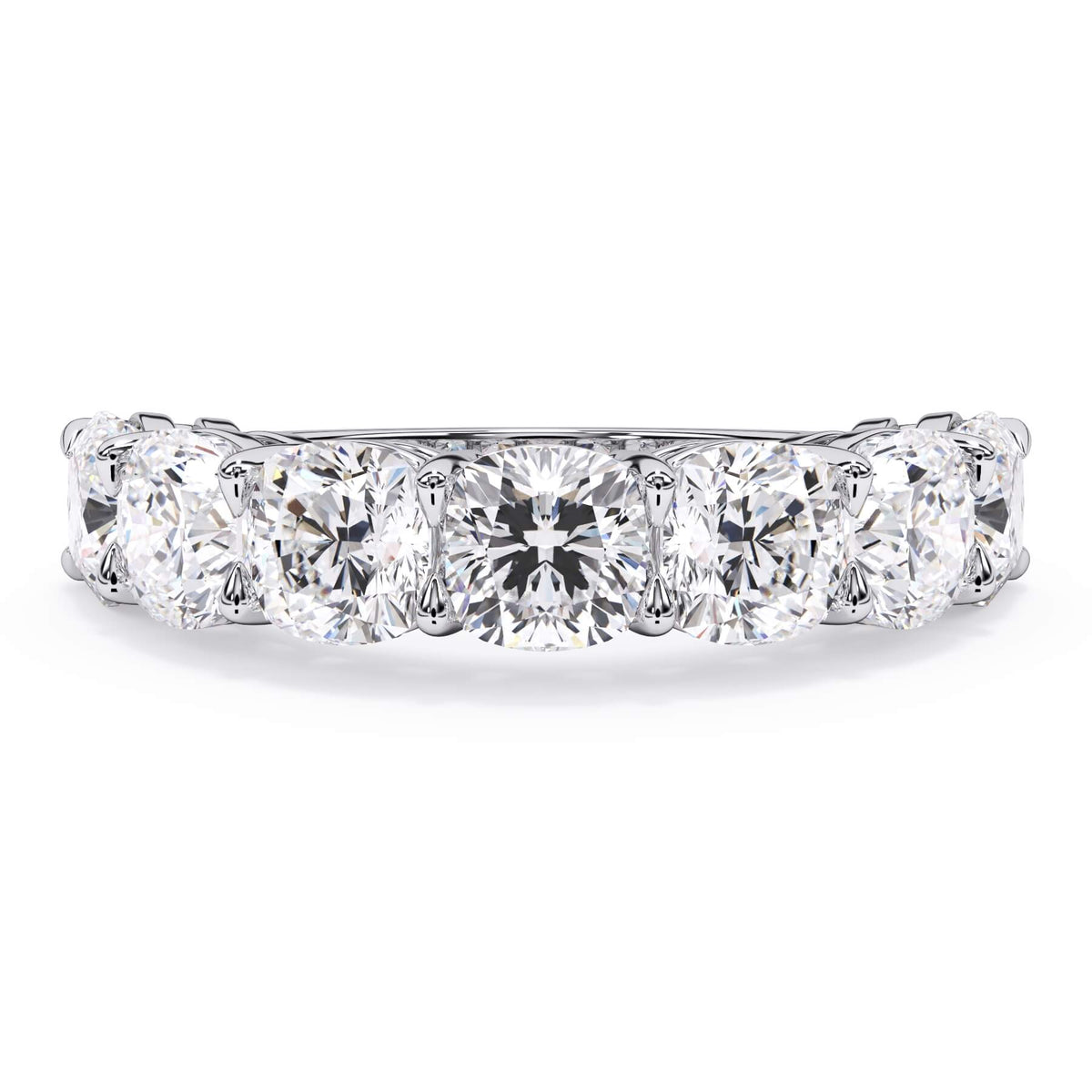A picture of a seven stone diamond wedding ring with cushion cut diamonds that are shared prong set in white gold or platinum on a white background with the ring facing forward, lying down.
