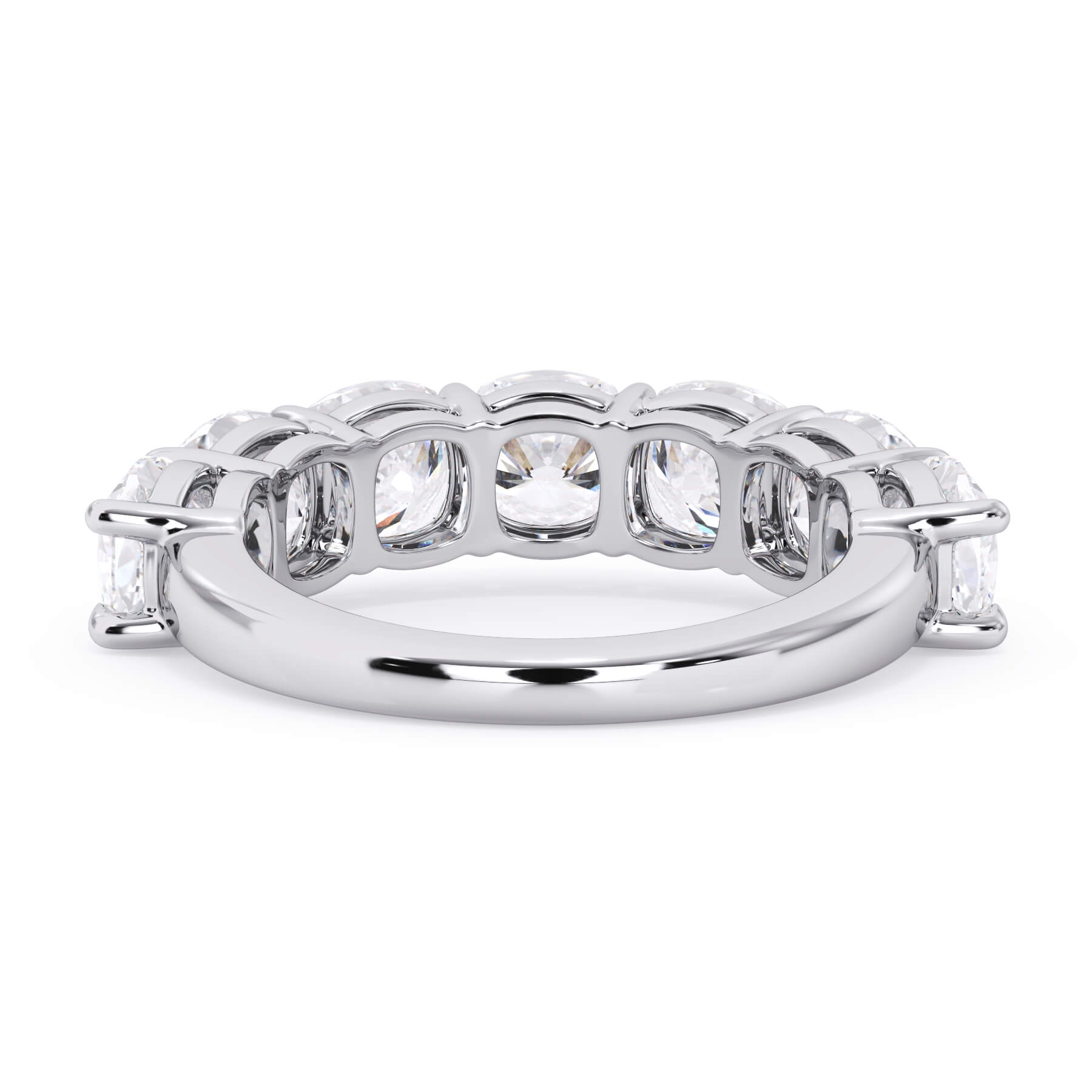 A picture of a seven stone diamond wedding ring with cushion cut diamonds that are shared prong set in white gold or platinum on a white background with a view of the underside of the ring.