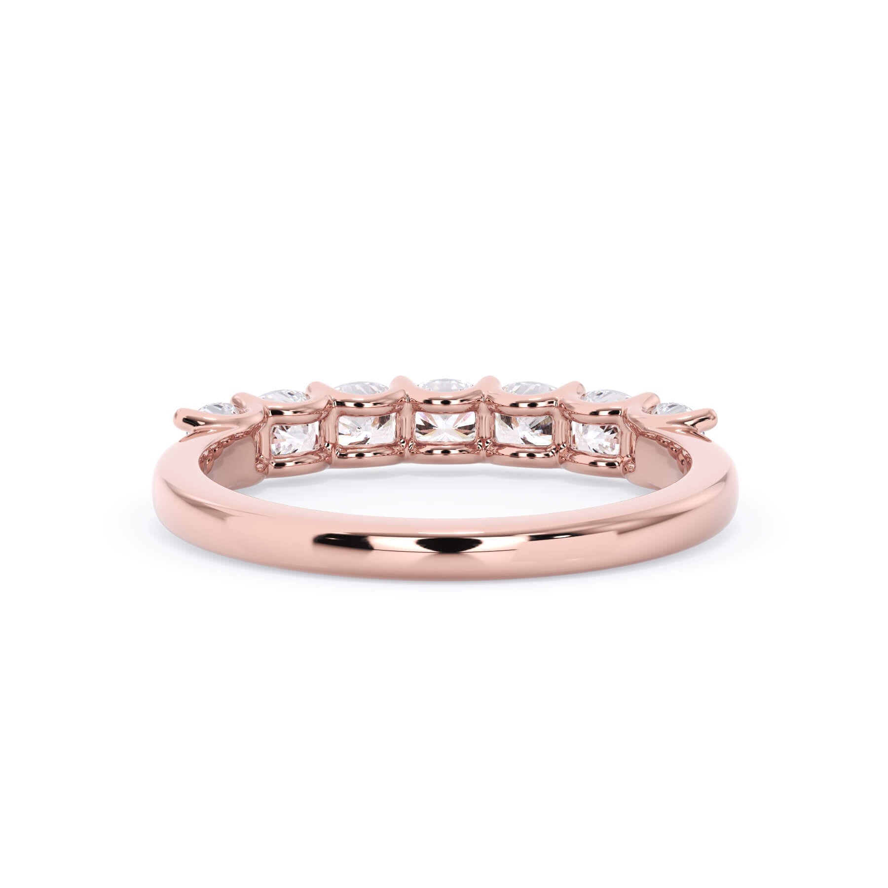 A picture of a seven stone diamond wedding ring with cushion cut diamonds that are U prong set in rose gold on a white background with a view of the underside of the ring.