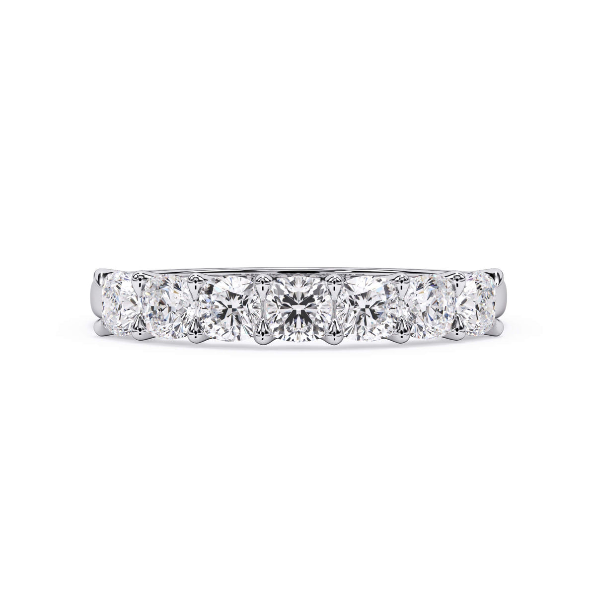 A picture of a seven stone diamond wedding ring with cushion cut diamonds that are U prong set in white gold or platinum on a white background with the ring facing forward, lying down.