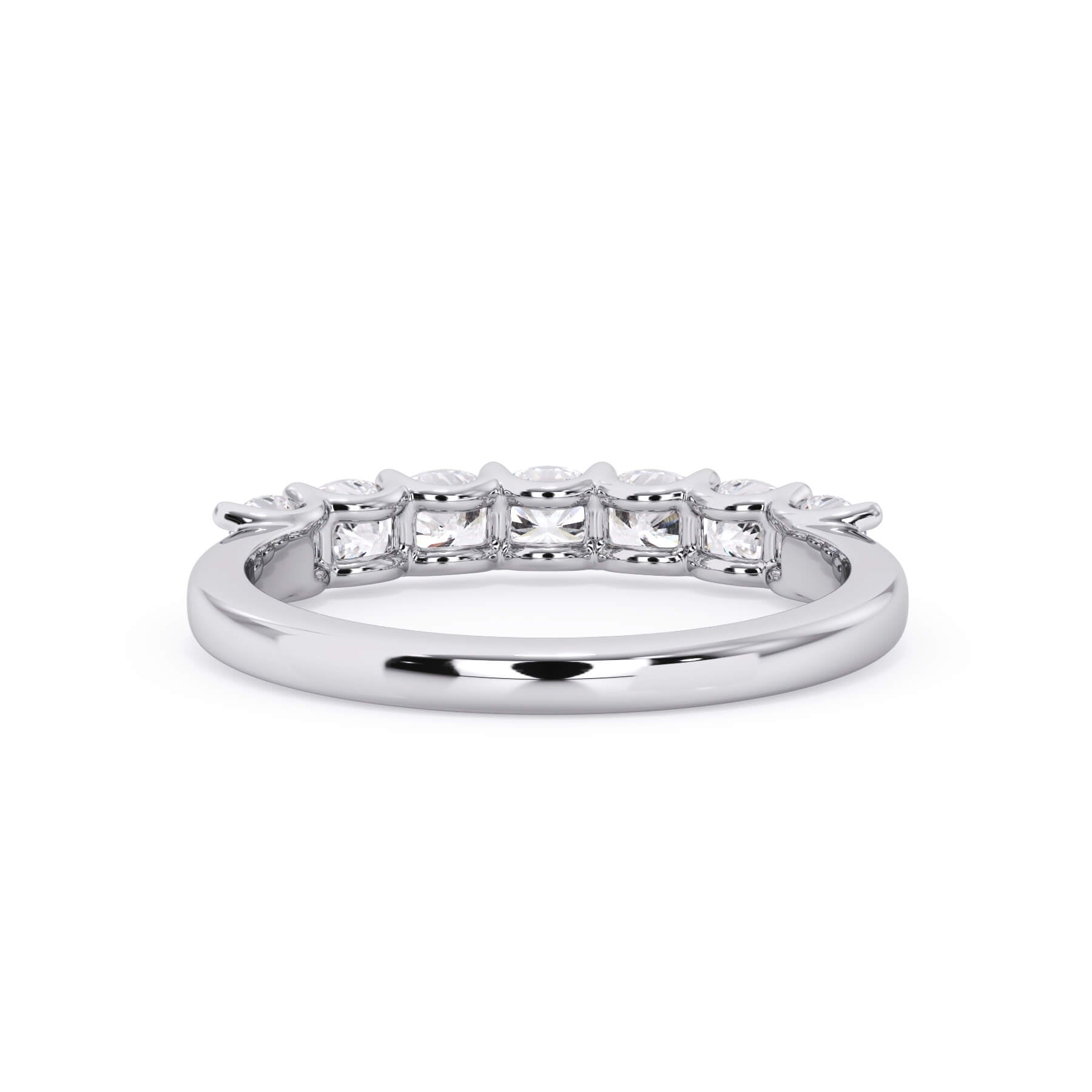 A picture of a seven stone diamond wedding ring with cushion cut diamonds that are U prong set in white gold or platinum on a white background with a view of the underside of the ring.