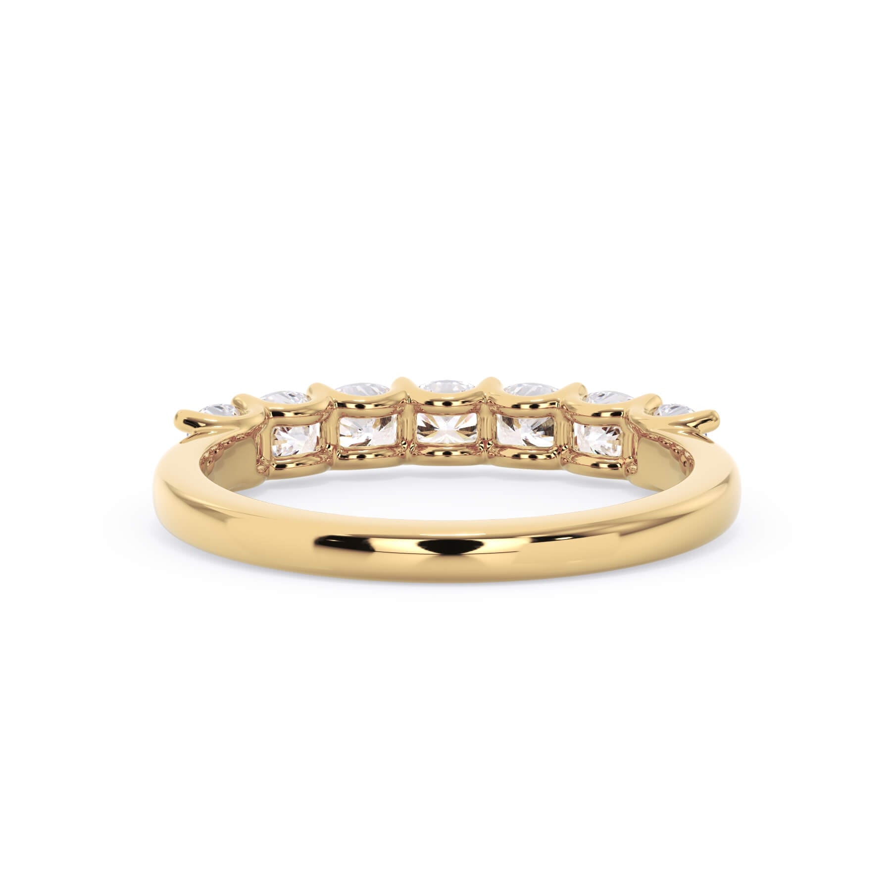A picture of a seven stone diamond wedding ring with cushion cut diamonds that are U prong set in yellow gold on a white background with a view of the underside of the ring.
