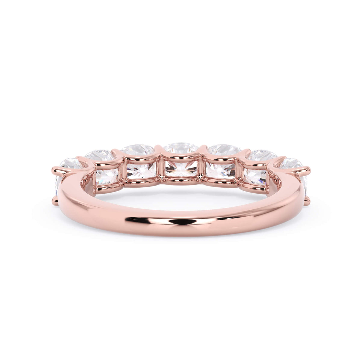 A picture of a seven stone diamond wedding ring with cushion cut diamonds that are U prong set in rose gold on a white background with a view of the underside of the ring.