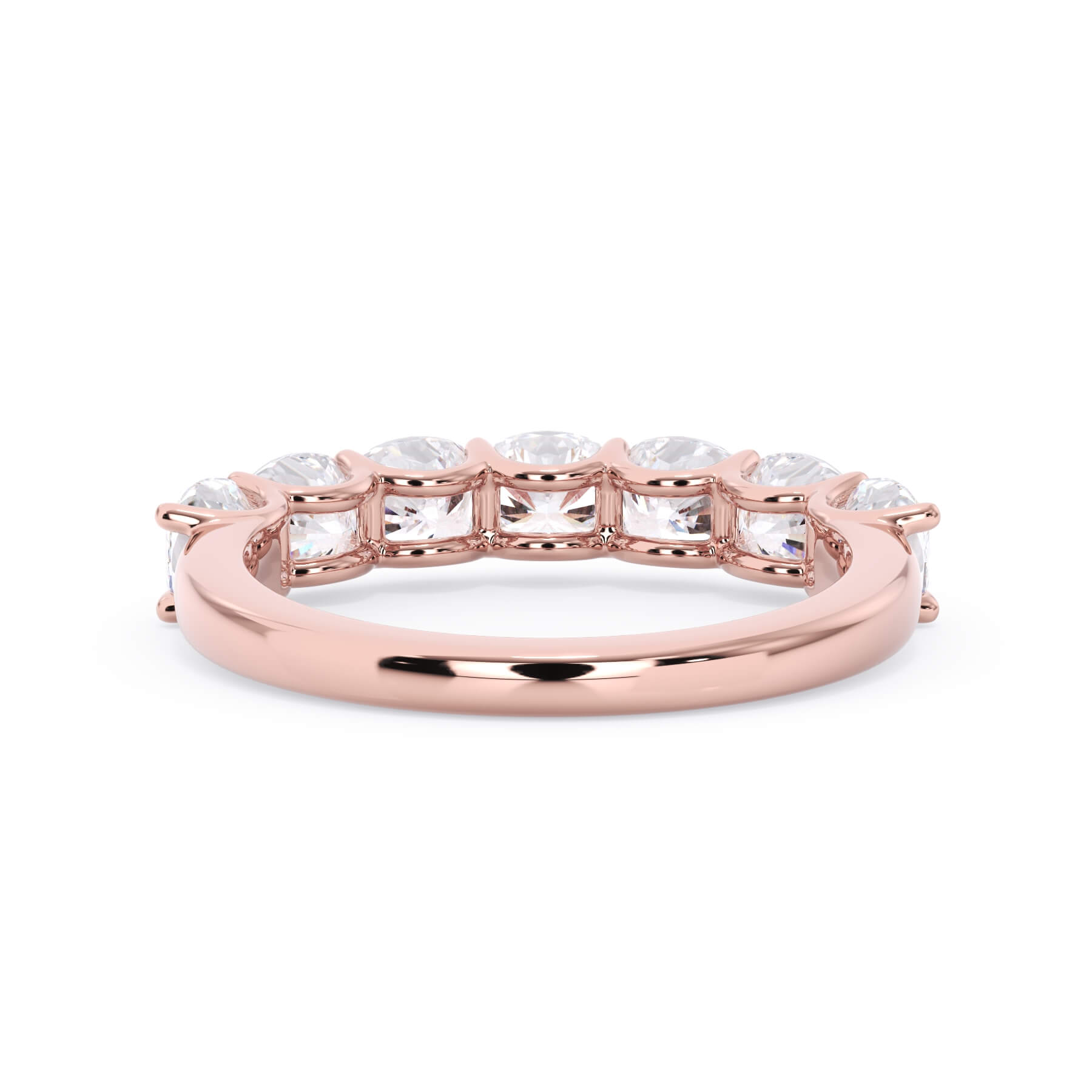 A picture of a seven stone diamond wedding ring with cushion cut diamonds that are U prong set in rose gold on a white background with a view of the underside of the ring.
