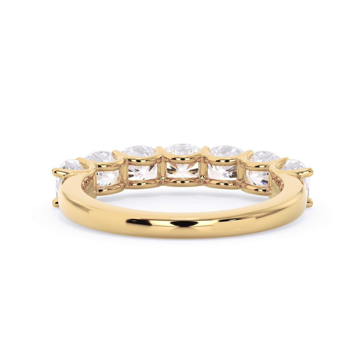 A picture of a seven stone diamond wedding ring with cushion cut diamonds that are U prong set in yellow gold on a white background with a view of the underside of the ring.