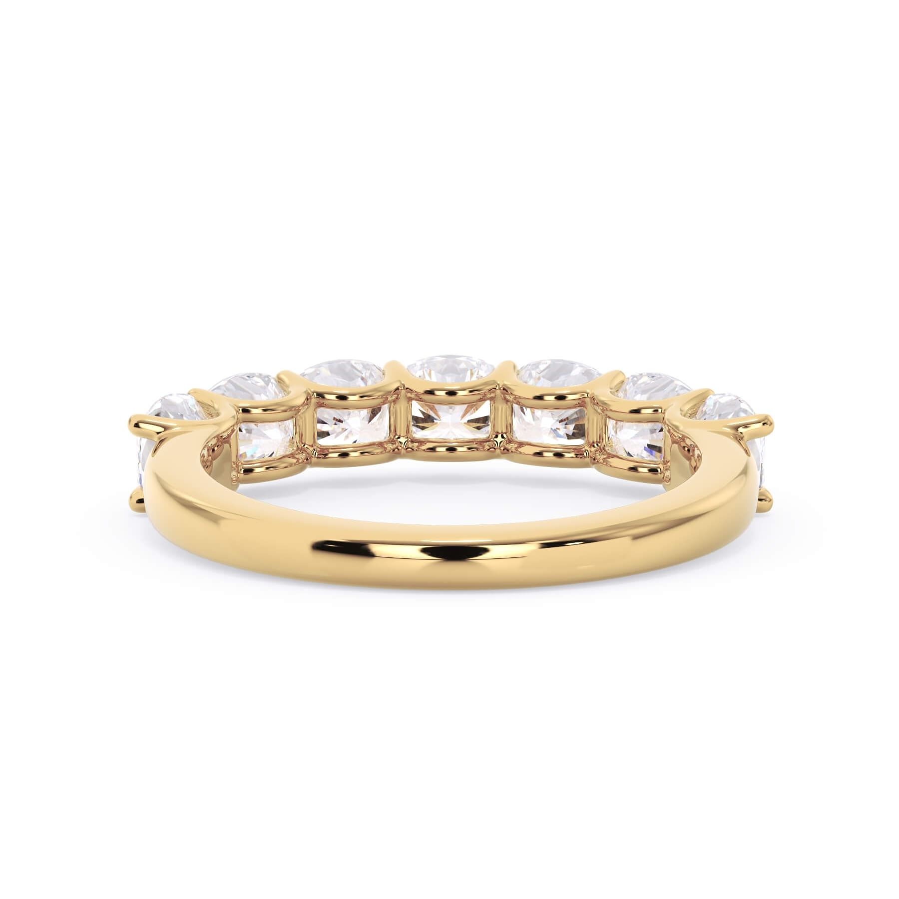 A picture of a seven stone diamond wedding ring with cushion cut diamonds that are U prong set in yellow gold on a white background with a view of the underside of the ring.