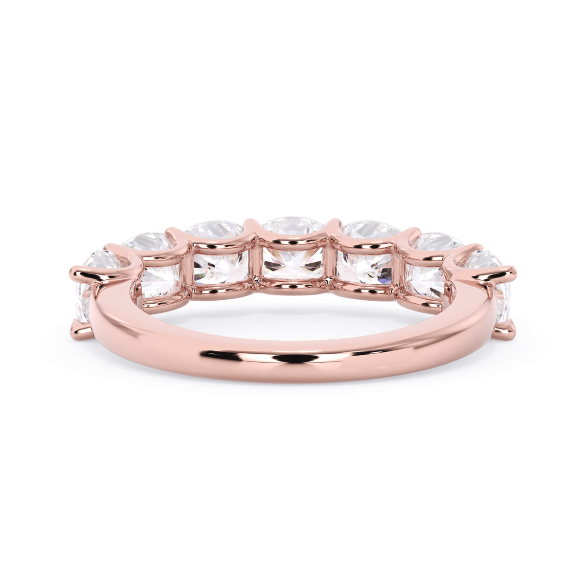 A picture of a seven stone diamond wedding ring with cushion cut diamonds that are U prong set in rose gold on a white background with a view of the underside of the ring.