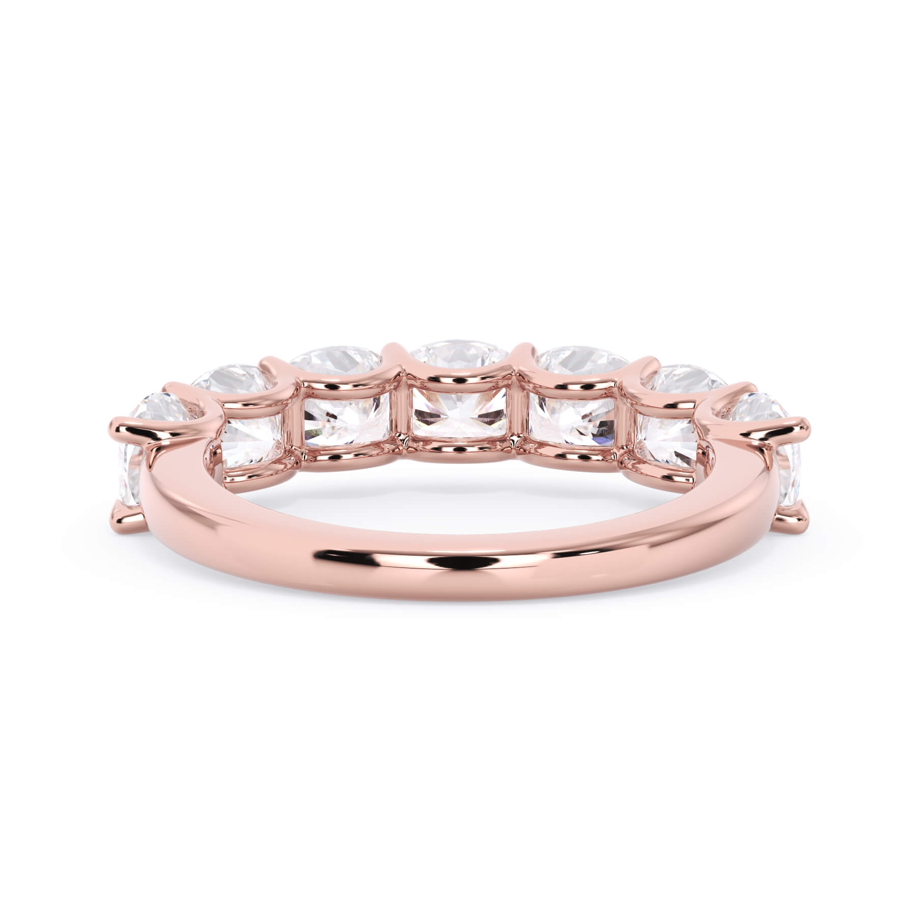 A picture of a seven stone diamond wedding ring with cushion cut diamonds that are U prong set in rose gold on a white background with a view of the underside of the ring.