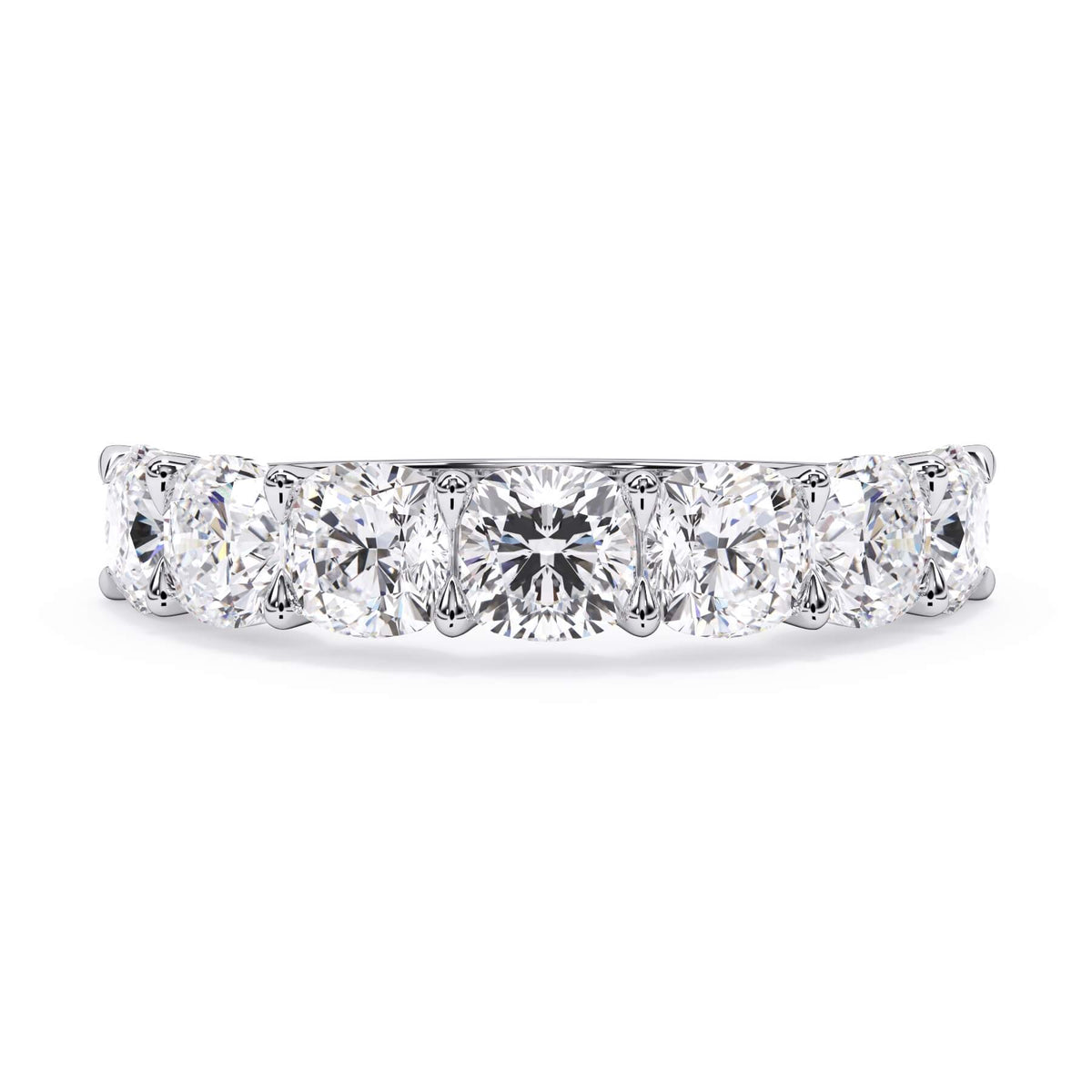 A picture of a seven stone diamond wedding ring with cushion cut diamonds that are U prong set in white gold or platinum on a white background with the ring facing forward, lying down.