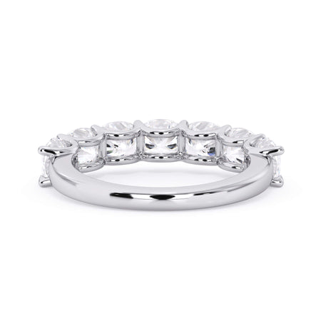 A picture of a seven stone diamond wedding ring with cushion cut diamonds that are U prong set in white gold or platinum on a white background with a view of the underside of the ring.