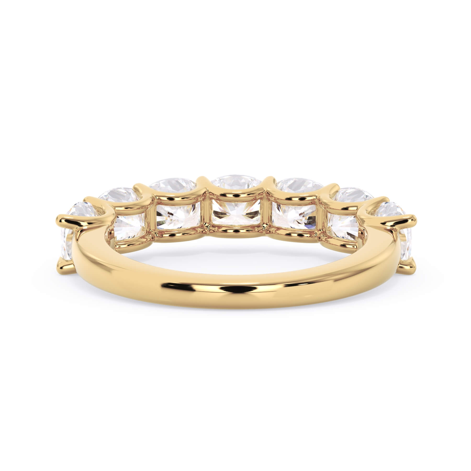 A picture of a seven stone diamond wedding ring with cushion cut diamonds that are U prong set in yellow gold on a white background with a view of the underside of the ring.