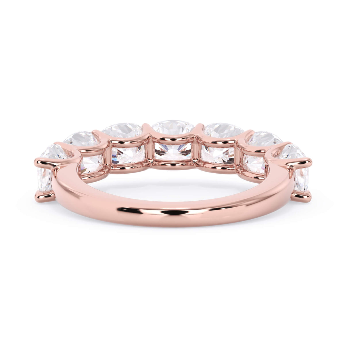 A picture of a seven stone diamond wedding ring with cushion cut diamonds that are U prong set in rose gold on a white background with a view of the underside of the ring.