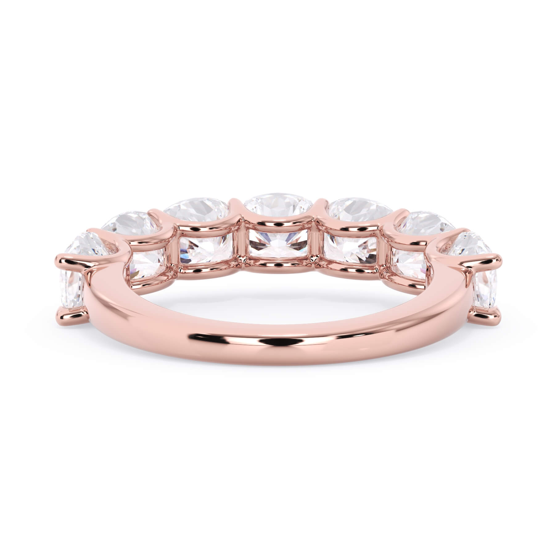 A picture of a seven stone diamond wedding ring with cushion cut diamonds that are U prong set in rose gold on a white background with a view of the underside of the ring.