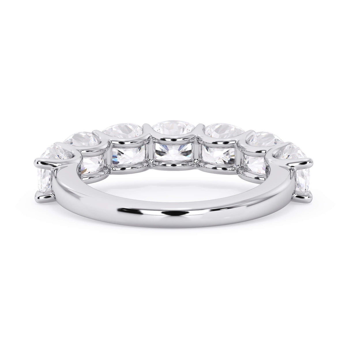 A picture of a seven stone diamond wedding ring with cushion cut diamonds that are U prong set in white gold or platinum on a white background with a view of the underside of the ring.