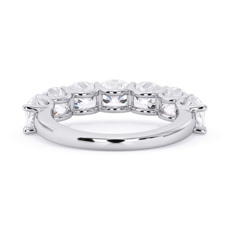 A picture of a seven stone diamond wedding ring with cushion cut diamonds that are U prong set in white gold or platinum on a white background with a view of the underside of the ring.