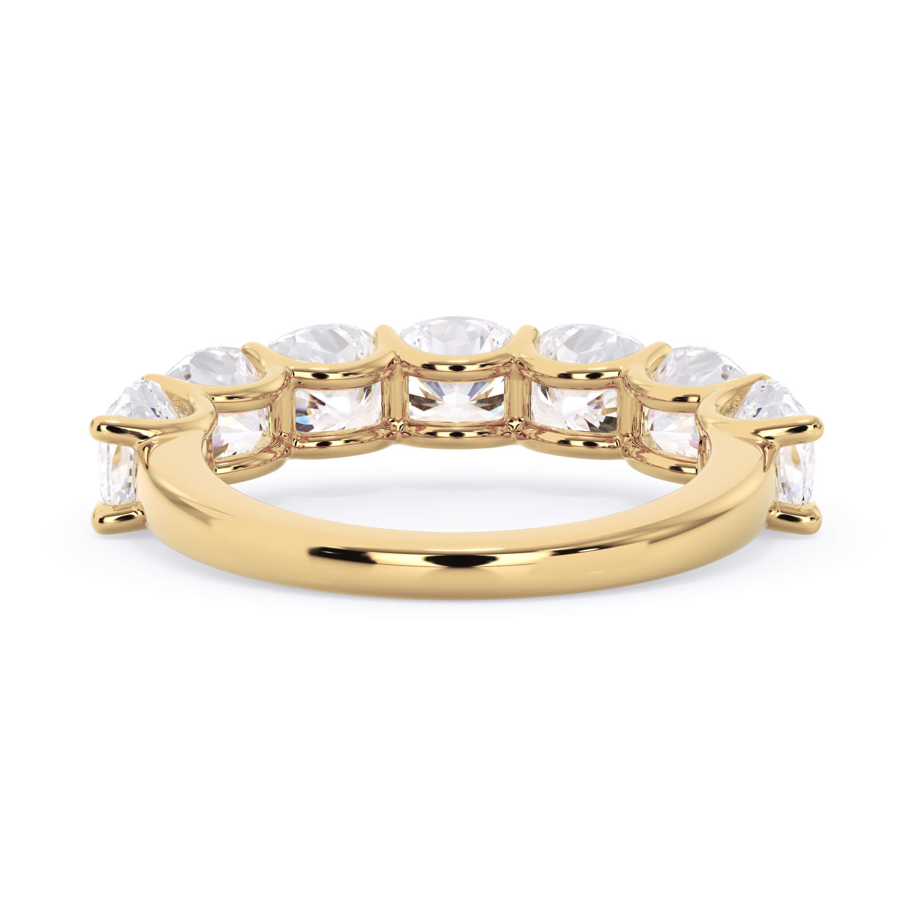 A picture of a seven stone diamond wedding ring with cushion cut diamonds that are U prong set in yellow gold on a white background with a view of the underside of the ring.