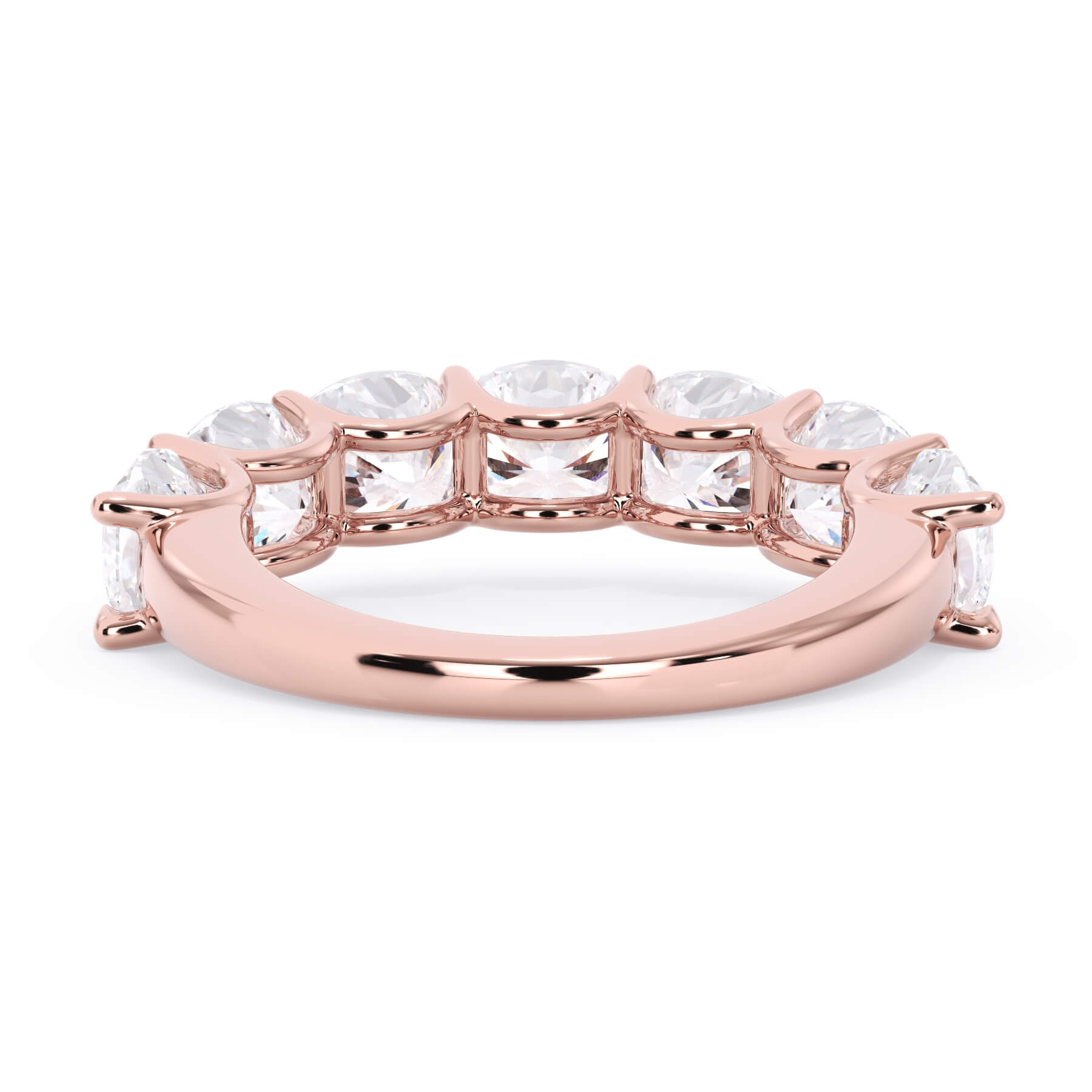 A picture of a seven stone diamond wedding ring with cushion cut diamonds that are U prong set in rose gold on a white background with a view of the underside of the ring.