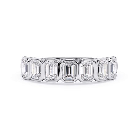 A picture of a seven stone diamond wedding ring with emerald cut diamonds that are bezel set in white gold or platinum on a white background with the ring facing forward, lying down.