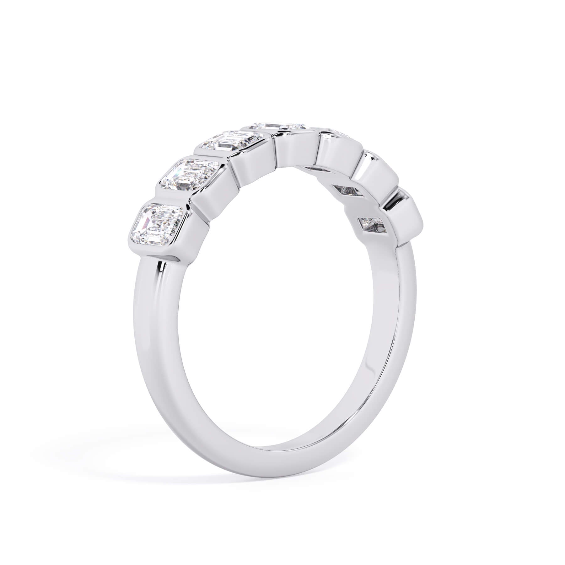 A picture of a seven stone diamond wedding ring with emerald cut diamonds that are bezel set in white gold or platinum on a white background with a slightly angled, through the finger view.