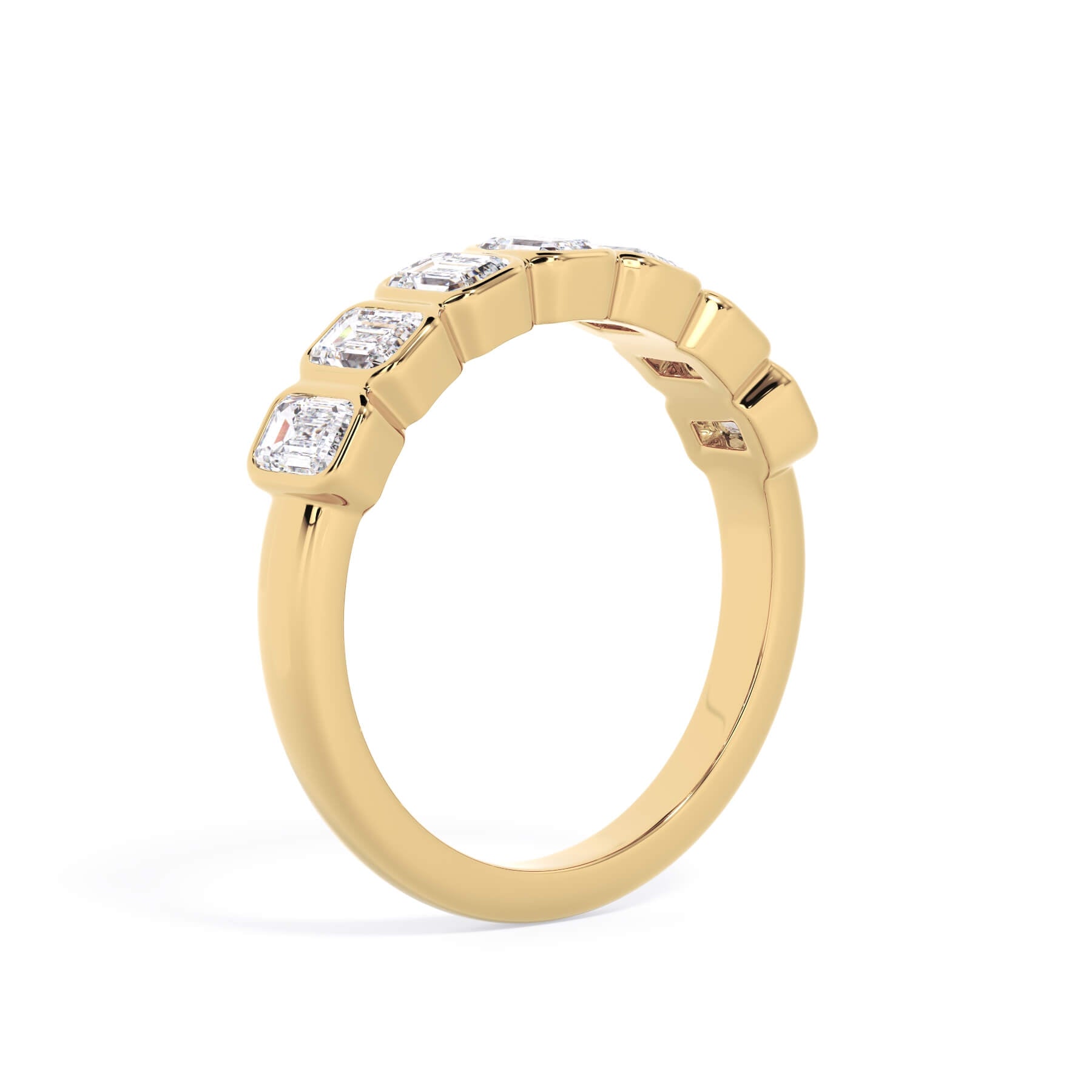 A picture of a seven stone diamond wedding ring with emerald cut diamonds that are bezel set in yellow gold on a white background with a slightly angled, through the finger view.