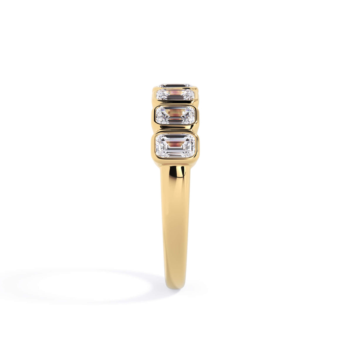 A picture of a seven stone diamond wedding ring with emerald cut diamonds that are bezel set in yellow gold on a white background with a side profile view.
